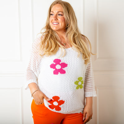 The white crochet Flower Top featuring a bold vibrant flower pattern across the front